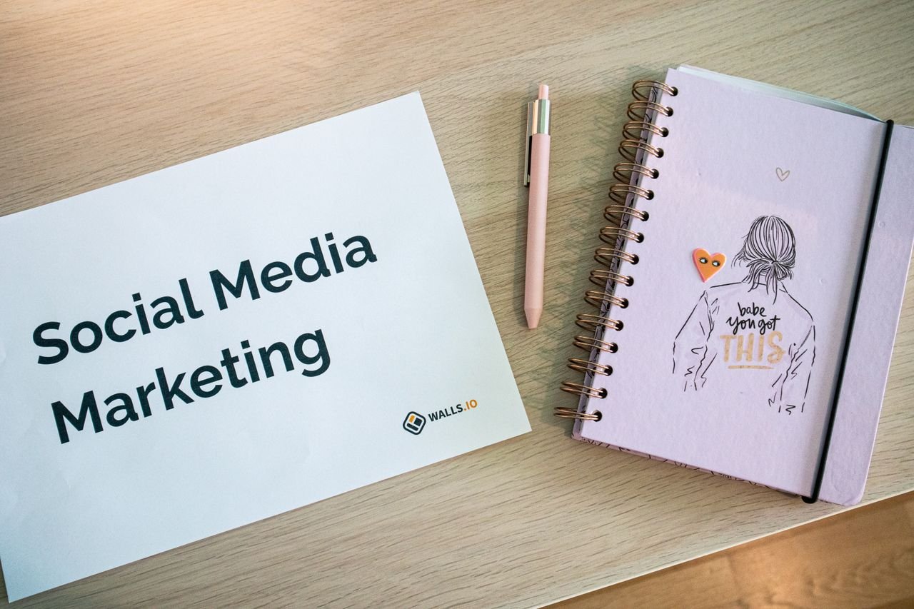 gallery-3 Flat lay of social media marketing paper and motivational notebook on wooden desk.