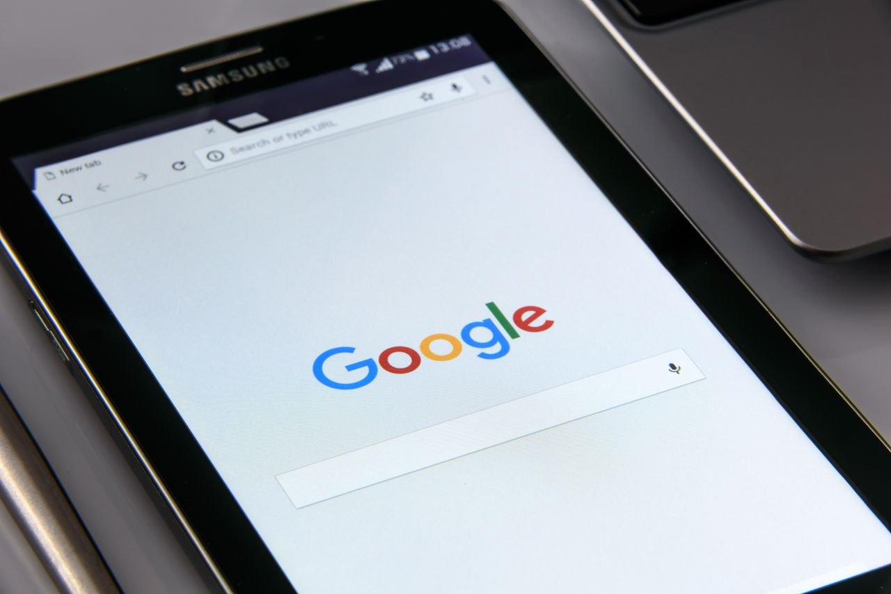 why-choose-us Close-up of a tablet displaying Google's search screen, emphasizing technology and internet browsing.