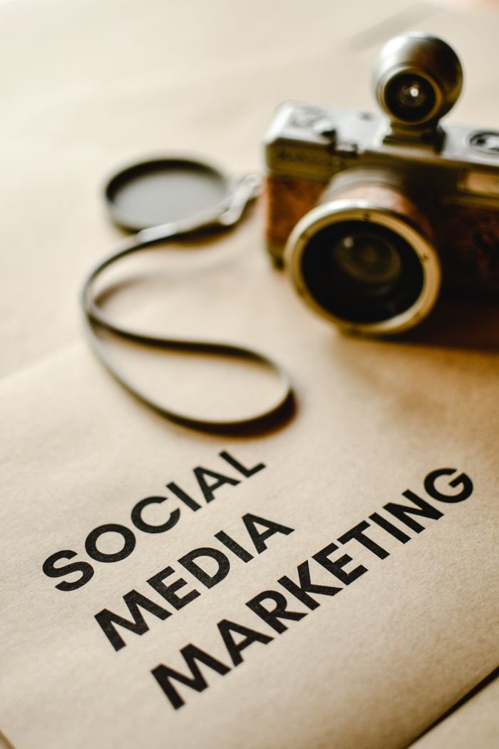 gallery-1 Close-up of a vintage camera on brown paper labeled with 'Social Media Marketing'.